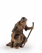 Shepherd kneeling with walking - stick 